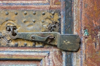Detail of bolt and lock on door with flaking paintwork, at the Palais Bahia, Bahia Palace, Marrakech.